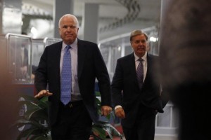 U.S. Republican Senators John McCain of Arizona and Lindsey Graham of South Carolina walk to a closed meeting with United States U.N. Ambassador Susan Rice on Capitol Hill in Washington
