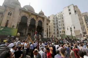 Anti-Mursi protesters and riot police officers gather outside al-Fath mosque at Ramses Square in Cairo