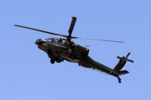 An Egyptian Apache helicopter flies in the direction towards al-Jura district in El-Arish city from Sheikh Zuwaid