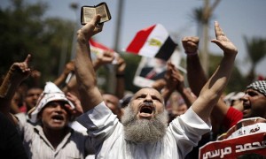 A protester, who supports former Egyptian President Mohamed Mursi, chants slogans during a rally in Cairo