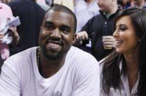 Rap musician West is and reality TV star Kardashian watch Miami Heat play New York Knicks in their NBA basketball game in Miami