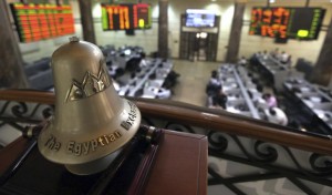 Traders are seen working below the Egyptian Exchange bell at the stock exchange in Cairo