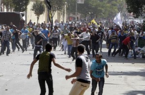 Supporters of deposed President Mursi and Muslim Brotherhood clash with anti-Mursi protesters during march in Cairo