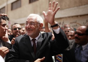 Presidential candidate Fotouh waves outside a polling station in Cairo