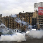 Supporters of the Muslim Brotherhood and ousted Egyptian President Mursi flee teargas fired by riot police at Tahrir Square in Cairo
