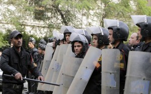 Riot police take positions as students of Cairo University shout slogans against the military and interior ministry during a demonstration in Cairo
