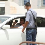 A Tunisian border policeman checks the identification papers of a Libyan at the border crossing of Ras el-Jedir Ben Guerdane