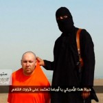 Still image from undated video of a masked Islamic State militant speaking next to man purported to be U.S. journalist Steven Sotloff at an unknown location