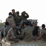 Members of forces loyal to former general Khalifa Haftar ride in a truck in the Benina area, east of Benghazi