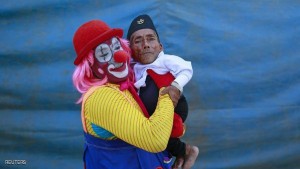The world's shortest man Chandra Bahadur Dangi, 72, is carried by a clown after an event at the Rambo Circus in Mumbai