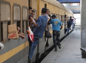 Egyptians cram onto an overcrowded train to head home for Eid holidays, at a train station in Cairo