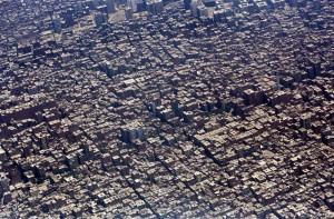 Buildings and houses are seen through the window of an airplane above Cairo