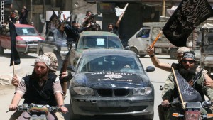 Fighters from Al-Qaeda's Syrian affiliate Al-Nusra Front drive in the northern Syrian city of Aleppo flying Islamist flags as they head to a frontline, on May 26, 2015. Once Syria's economic powerhouse, Aleppo has been divided between government control in the city's west and rebel control in the east since shortly after fighting there began in mid-2012. AFP PHOTO / AMC / FADI AL-HALABI        (Photo credit should read Fadi al-Halabi/AFP/Getty Images)