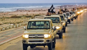 An image made available by propaganda Islamist media outlet Welayat Tarablos on February 18, 2015, allegedly shows members of the Islamic State (IS) militant group parading in a street in Libya's coastal city of Sirte, which lies 500 kilometres (310 miles) east of the capital, Tripoli. Egyptian F-16s bombed militant bases in the eastern Libyan city of Derna in mid-February after the Islamic State group in Libya released a gruesome video showing the beheadings of a group of Egyptian Coptic Christians who had gone to the North African country seeking work. AFP PHOTO / HO / WELAYAT TARABLOS === RESTRICTED TO EDITORIAL USE - MANDATORY CREDIT "AFP PHOTO / HO / WELAYAT TARABLOS" - NO MARKETING NO ADVERTISING CAMPAIGNS - DISTRIBUTED AS A SERVICE TO CLIENTS FROM ALTERNATIVE SOURCES, AFP IS NOT RESPONSIBLE FOR ANY DIGITAL ALTERATIONS TO THE PICTURE'S EDITORIAL CONTENT, DATE AND LOCATION WHICH CANNOT BE INDEPENDENTLY VERIFIED ===