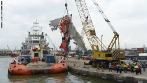 Indonesian crews and workers remove the fuselage of AirAsia QZ8501 from a vessel at the Tanjung Priok port in Jakarta on March 2, 2015. Indonesia has retrieved the final major part of the fuselage of an AirAsia jet that crashed into the Java Sea in December, killing all 162 people on board, officials said on February 28. AFP PHOTO / ADEK BERRY        (Photo credit should read ADEK BERRY/AFP/Getty Images)