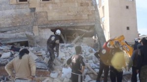 People gather near a destroyed building said to be a Medecins Sans Frontieres (MSF) supported hospital in Marat al Numan, Idlib, Syria, February 15, 2016 in this still image taken from a video on a social media website. French charity Doctors Without Borders/Medecins Sans Frontieres (MSF) said in a statement that at least eight staff were missing after four rockets hit a hospital that it supported in the province of Idlib in north western Syria. REUTERS/Social Media Website via Reuters TVATTENTION EDITORS - THIS PICTURE WAS PROVIDED BY A THIRD PARTY. REUTERS IS UNABLE TO INDEPENDENTLY VERIFY THE AUTHENTICITY, CONTENT, LOCATION OR DATE OF THIS IMAGE. EDITORIAL USE ONLY. NOT FOR SALE FOR MARKETING OR ADVERTISING CAMPAIGNS. NO RESALES. NO ARCHIVE. THIS PICTURE IS DISTRIBUTED EXACTLY AS RECEIVED BY REUTERS, AS A SERVICE TO CLIENTS