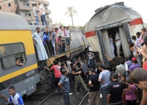 People gather at the scene of a train derailment in the Giza neighbourhood of Badrashin on the outskirts of Cairo July 17, 2012. The train was travelling from southern Egypt towards Cairo when it derailed in a Cairo suburb on Tuesday and 15 people were injured, security and medical officials said, denying early reports that passengers had died in the crash. REUTERS/Stringer  (EGYPT - Tags: DISASTER TRANSPORT)