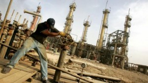 BAGHDAD, IRAQ - NOVEMBER 5: An Iraqi worker adjusts a control valve at the Daura oil refinery on November 5, 2009 in Baghdad, Iraq. Iraq and a grouping of U.S and European oil companies Exxon Mobil Corp and Royal Dutch Shell PLC signed a $50 billion contract today to develop the West Qurna oilfield, two days after the Iraqi South Oil Company signed a technical service contract with Britain's BP and China's CNPC to develop the Rumaila oilfield. The Iraqi government is trying to attract foreign investment, especially in the oil sector, in hopes of reviving its war-torn economy. Iraq has the third largest oil reserve in the world but it is producing way below its potential.  (Photo by Muhannad Fala'ah/Getty Images)