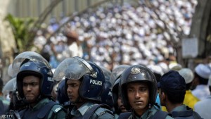 Bangladeshi police stand guard as the hardline Islamists protest outside the national mosque Baitul Mukarram in Dhaka on March 25, 2016. Thousands of Bangladeshi hardline Islamists have rallied across the country against an "infidels'-initiated" move to scrap Islam as the state-religion in the Muslim-majority nation. Nearly seven thousand activists of hardline group Hefazat-e-Islam carried banners and festoons and chanted slogans on Dhaka high roads after the Friday prayer booing the government for not taking "sufficient actions" to stop "mockery" against Islam, religion of nearly 90 percent of the population of the country. / AFP / MUNIR UZ ZAMAN        (Photo credit should read MUNIR UZ ZAMAN/AFP/Getty Images)