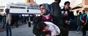 A woman holds her baby as migrants wait at the port of Piraeus on February 23, 2016 upon their arrival from the islands of Lesbos and Chios. Greek authorities allow Syrians and Iraqis continue their journey towards the borders after their arrival to the port , while other nationalities are prevented from boarding the buses. Thousands of refugees were left stranded in Greece, after Macedonia abruptly closed it border to Afghans, creating a fresh bottleneck as European countries scramble to respond to the continents worst refugee crisis since World War II. More than 100,000 migrants and refugees have crossed the Mediterranean to Greece and Italy so far this year, and 413 have lost their lives trying, the International Organisation for Migration said on February 23, 2016.  / AFP / LOUISA GOULIAMAKI        (Photo credit should read LOUISA GOULIAMAKI/AFP/Getty Images)