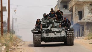 TOPSHOT - Opposition fighters drive a tank in a rebel-held area of the southern Syrian city of Daraa, during re-newed clashes with regime loyalists on May 10, 2016. / AFP / MOHAMAD ABAZEED        (Photo credit should read MOHAMAD ABAZEED/AFP/Getty Images)